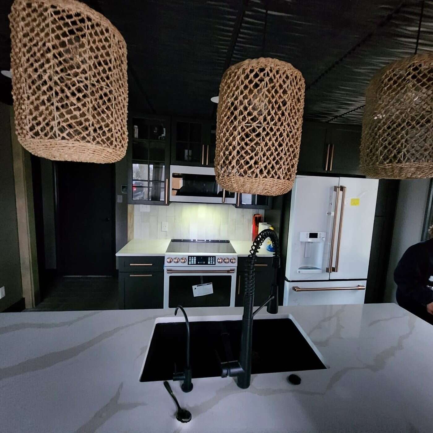 Kitchen with black tongue-and-groove ceiling and brass hardware