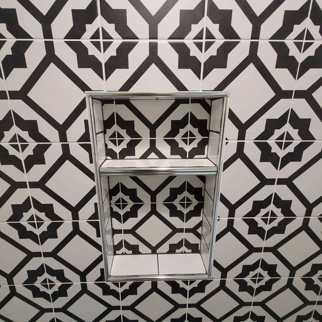 Patterned tile shower niche with chrome trim