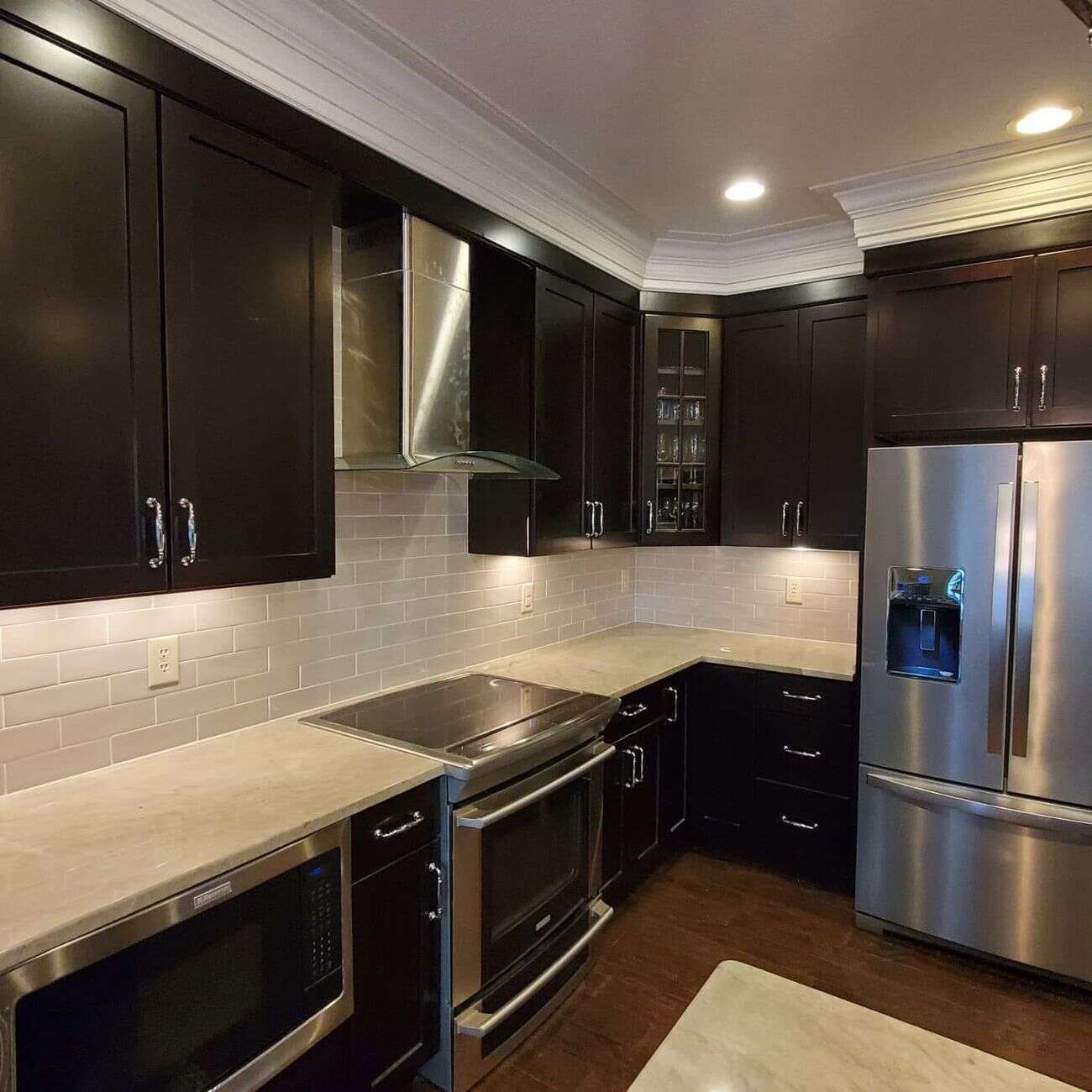 Kitchen with espresso cabinets and cream subway tile backsplash