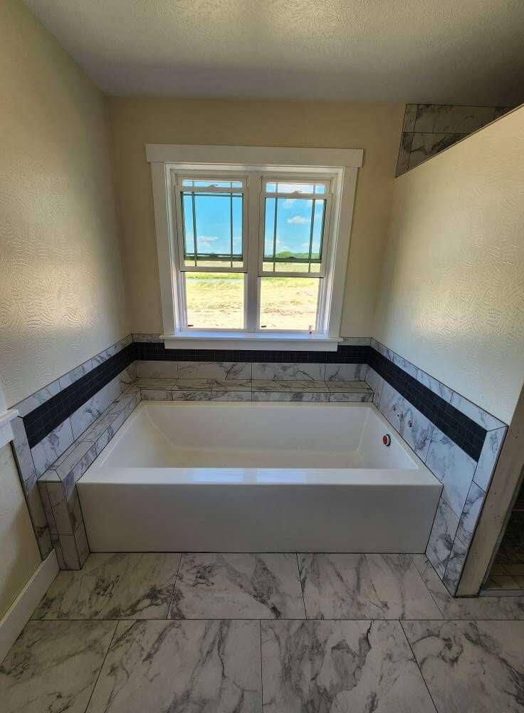 Master bathroom with marble-look porcelain floor, double vanity and walk-in tile shower