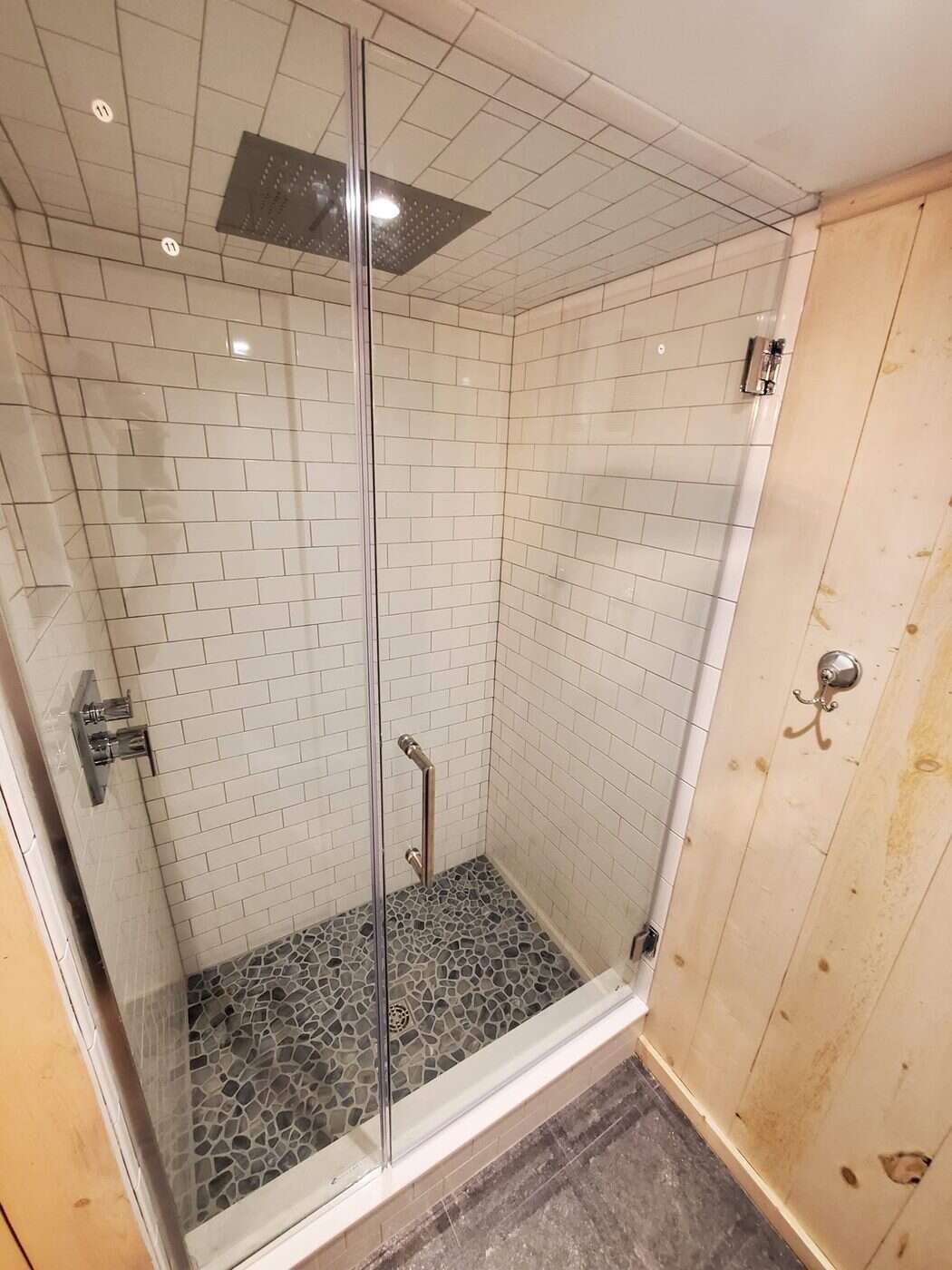 Bathroom after remodel with pebble tile shower floor